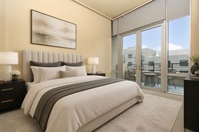 Denver apartment for rent - A bedroom with a large bed and a painting on the wall.