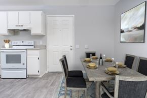 Santa Ana apartment for rent - A modern kitchen with a dining table set for two.