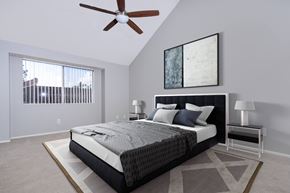 Santa Ana apartment for rent - A bedroom with a large bed and a ceiling fan.