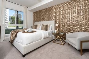 Irvine apartment for rent - A bedroom with a large bed and a patterned wallpaper.