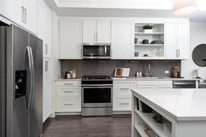 Irvine apartment for rent - A modern kitchen with white cabinets and stainless steel appliances.