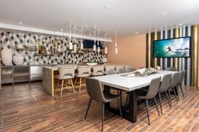 Irvine apartment for rent - A modern dining room with a long table and chairs.