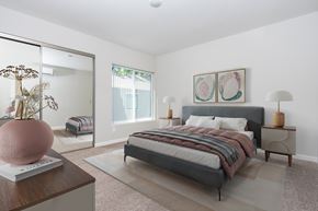 Walnut Creek apartment for rent - A bedroom with a large bed and a vase on a table.