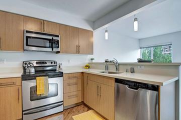 Seattle apartment for rent - A kitchen with wooden cabinets and stainless steel appliances.