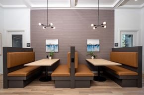 University Place apartment for rent - A dining area with two booths and a table in the middle.