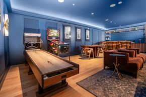 Redmond apartment for rent - A room with a shuffleboard table and a pool table.