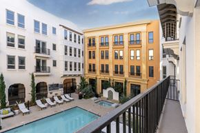 Montclair apartment for rent - A pool is surrounded by lounge chairs in a courtyard.