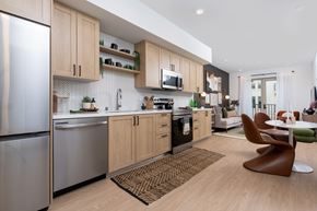 Montclair apartment for rent - A modern kitchen with wooden cabinets and a refrigerator.