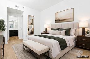 Cupertino apartment for rent - A bedroom with a large bed and a painting on the wall.