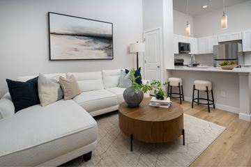 Longmont apartment for rent - A living room with a white couch and a coffee table in the center.