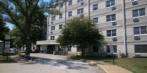 Elyria apartment for rent - an apartment building with a tree in front of it