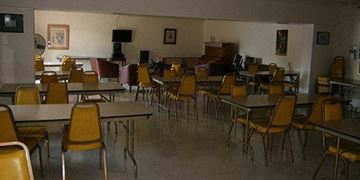 Elyria apartment for rent - a dining room with tables and chairs and a piano