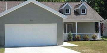 Lorain apartment for rent - a white garage door in front of a house