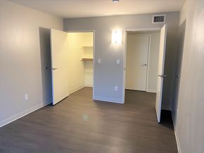 Huntington Park apartment for rent - a room with a hard wood floor and a hallway with two doors