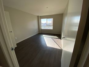 Huntington Park apartment for rent - an empty living room with wood floors and a window