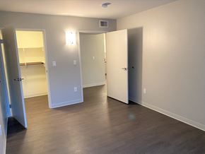 Huntington Park apartment for rent - a living room with a hard wood floor and a mirrored closet