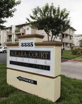 Anaheim apartment for rent - a solar court sign in front of an apartment building