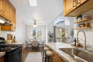 Edmonds apartment for rent - A kitchen with a black stove top oven and a white counter top.