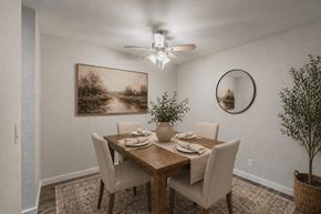 Edmonds apartment for rent - A dining room with a table set for four and a painting on the wall.