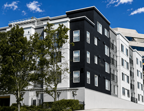 Bellevue apartment for rent - A modern building with black and white sections and a clear blue sky above.