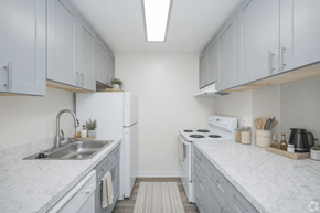 Everett apartment for rent - A kitchen with white cabinets and marble countertops.