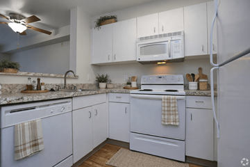 Seattle apartment for rent - A kitchen with white cabinets and appliances.