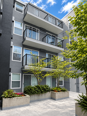 Bellevue apartment for rent - A modern apartment building with balconies and potted plants.