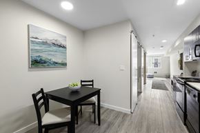 Shoreline apartment for rent - a dining area with a table and chairs and a kitchen in the background at Arabella Apartment Homes, Shoreline, WA