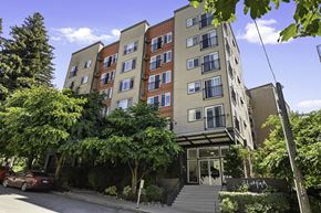 Seattle apartment for rent - Front view of property building with an awning and trees for shade at Illumina Apartment Homes, Seattle, WA