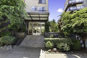 Seattle apartment for rent - Property Entrance stairs with bushes surrounding the front of it  at Illumina Apartment Homes, WA 98102