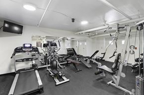 Seattle apartment for rent - Fitness Facilities complete with various exercise equipment and television at King Arthurs Court, Seattle, WA, 98125