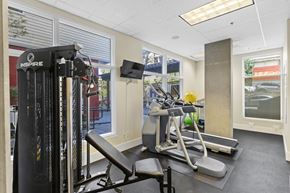 Seattle apartment for rent - Fitness Facility with exercise equipment and windows facing outdoor view at Promenade at the Park Apartment Homes, Washington