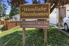 Edmonds townhouse for rent - Property Signage with Grass Area underneath at Woodlake Townhomes, Edmonds, 98026