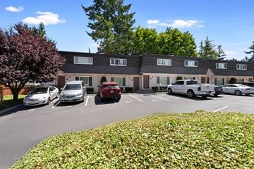Edmonds townhouse for rent - A parking lot with cars and a building in the background.