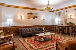 Seattle apartment for rent - A living room with a grey sofa and a chandelier.