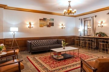 Seattle apartment for rent - A living room with a grey sofa and a chandelier.