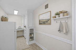 Seattle apartment for rent - A kitchen with a white refrigerator and a white cabinet with glass doors.