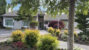Lynnwood apartment for rent - A building with a grey roof and a white sign on it.