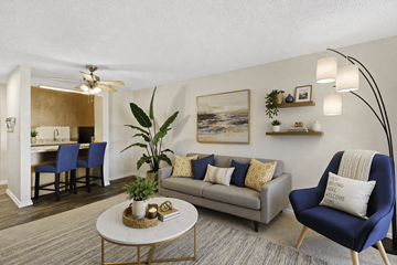 Edmonds apartment for rent - A living room with a blue chair and a grey couch.