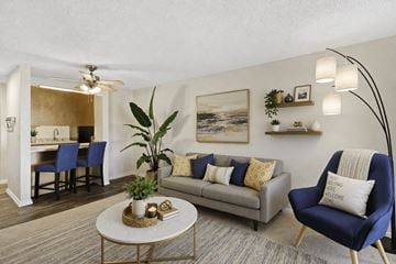 Edmonds apartment for rent - A living room with a blue chair and a grey couch.