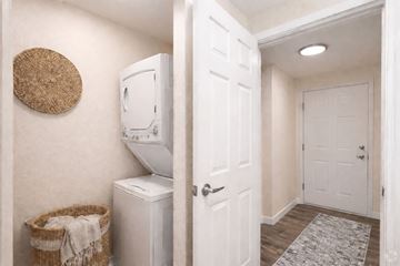 Edmonds apartment for rent - A white laundry machine sits next to a basket in a small room.