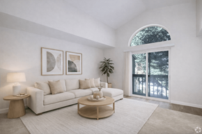 Edmonds apartment for rent - A living room with a white couch, a coffee table, and a potted plant.