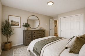 Edmonds apartment for rent - A bedroom with a large bed and a round mirror on the wall.