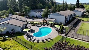 Lynnwood apartment for rent - A pool surrounded by a fence and trees.