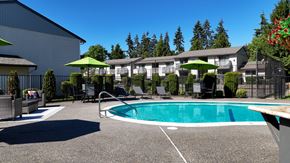 Lynnwood apartment for rent - A pool area with a green umbrella and chairs.