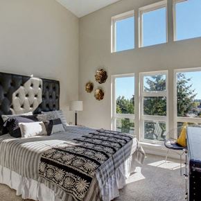 Seattle apartment for rent - a bedroom with a large bed and a large window