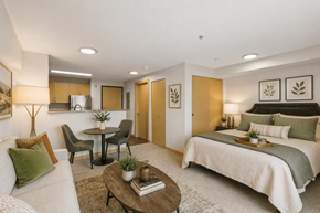 Tacoma apartment for rent - A well-lit bedroom with a bed, couch, and dining table.