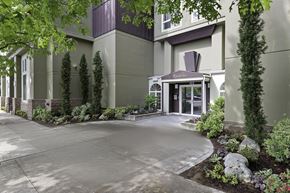 Bellevue apartment for rent - Entrance Image of Apartment Building with Decorative Landscaping to Welcome People In at Excalibur Apartment Homes, Bellevue, WA