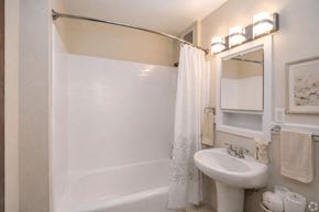 Seattle apartment for rent - A white bathroom with a white sink and a white bathtub.