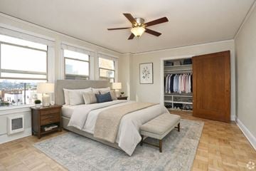 Seattle apartment for rent - A bedroom with a large bed and a ceiling fan.